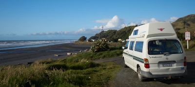 Freedom camping tips for New Zealand - campervan on a beach